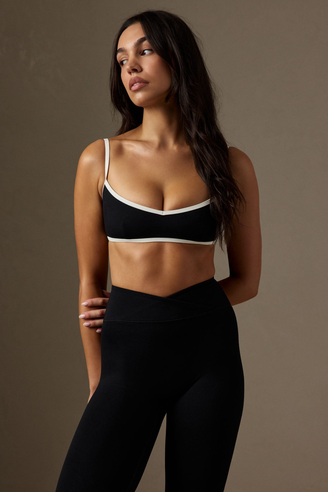 Angled top view of Fairfax Legging 27-inch in black showcasing high V waistband and slim fit on neutral background