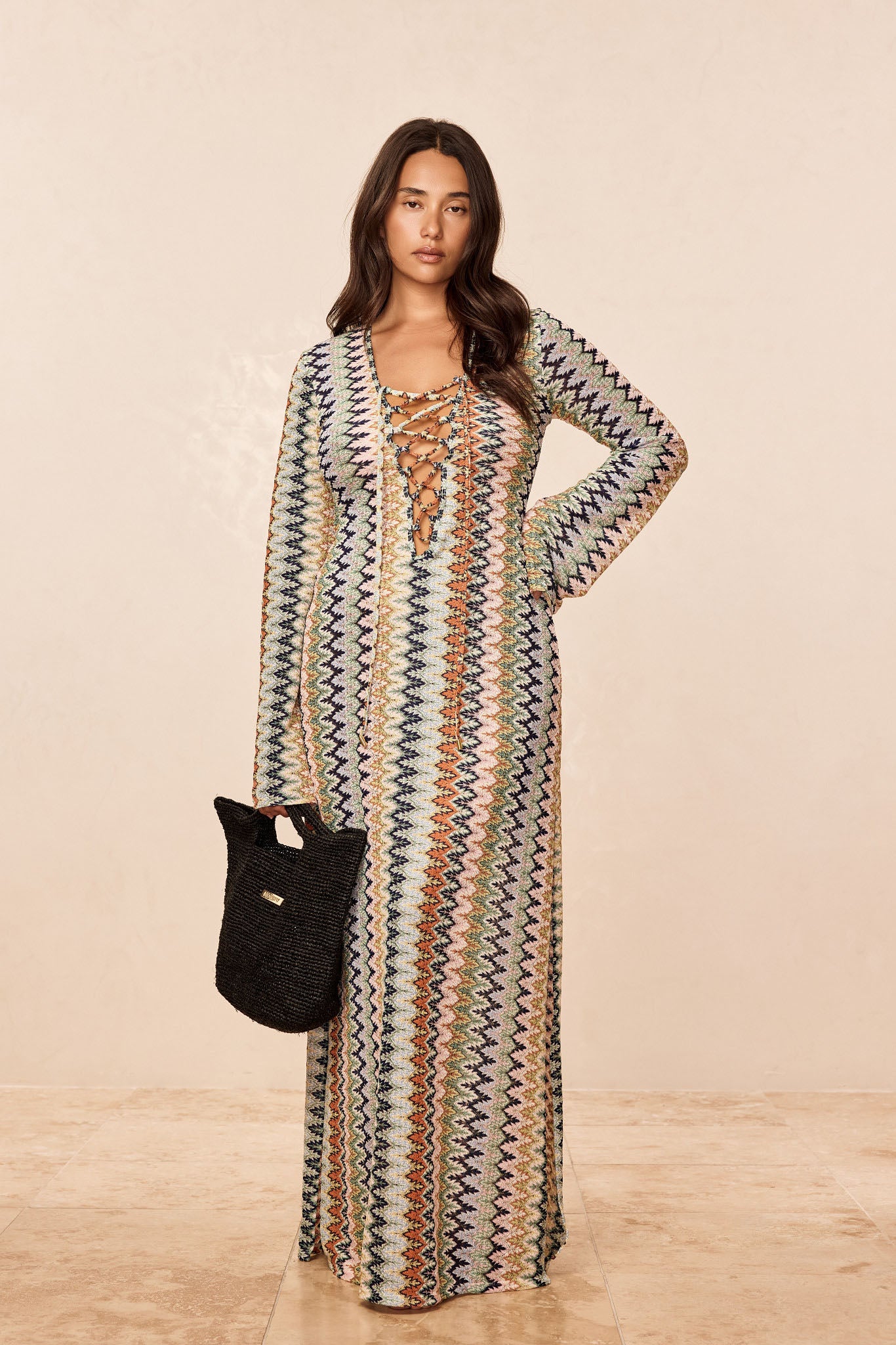 Front view of Corossol Dress Porto Cervo Multi with lace up V neck and multicolored zigzag knit on beige background
