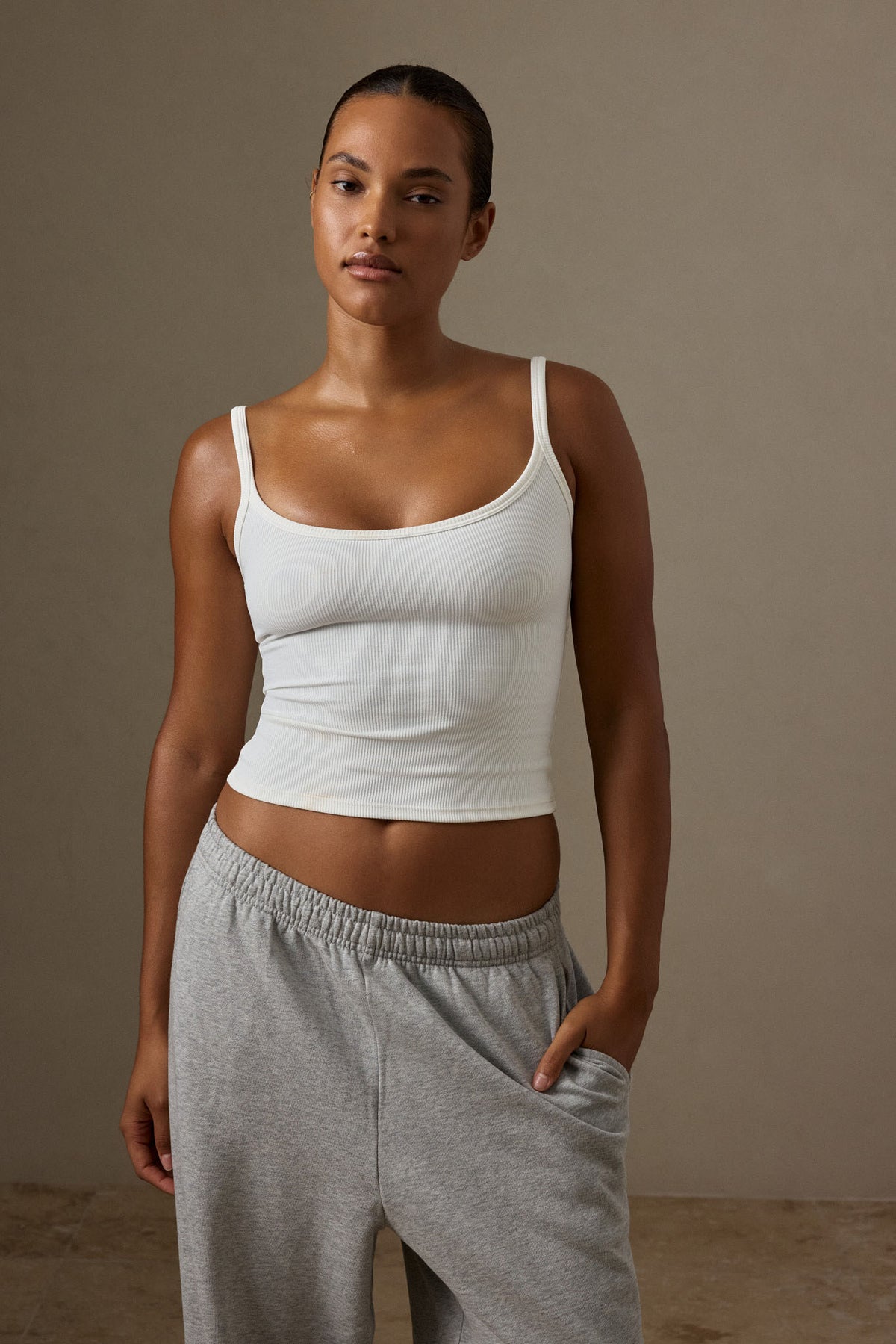 Front view of the Devin Tank in White Thin Rib showcasing its scoop neckline and thin rib texture on a model