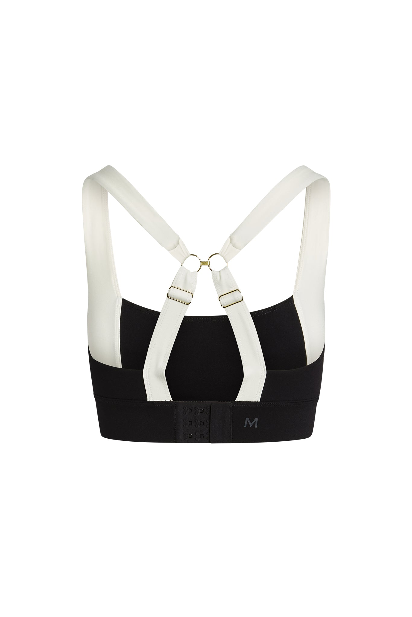 Back view of black-and-white sports bra with adjustable crossover straps, hook-and-eye band closure and letter M on the band.