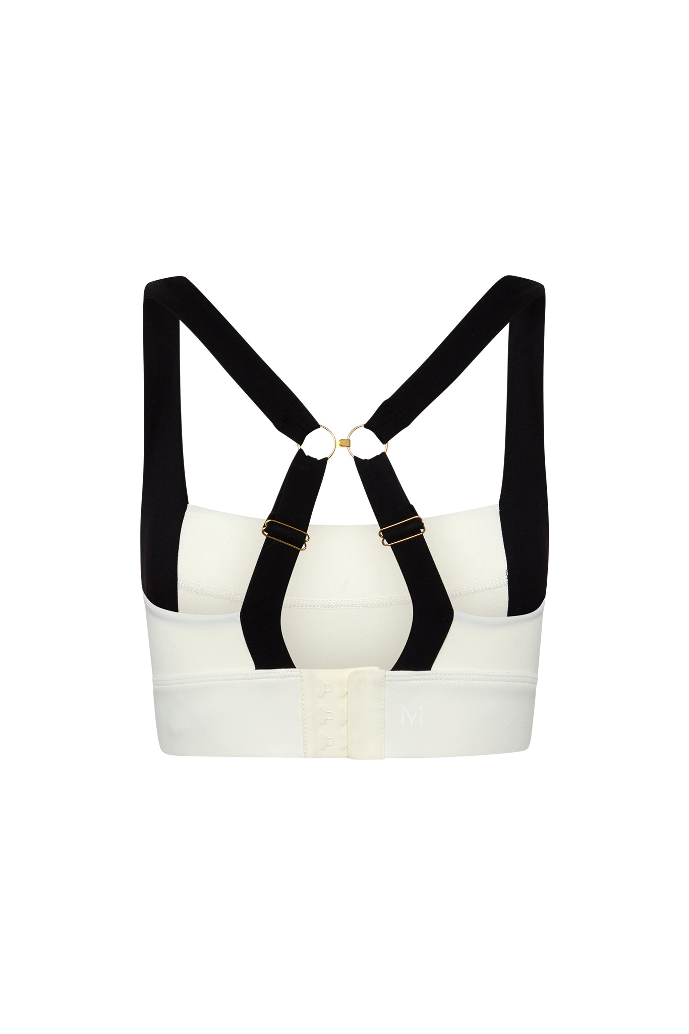 White sports bra back with black crossed adjustable straps, gold hardware, hook-and-eye closure, embroidered M on band