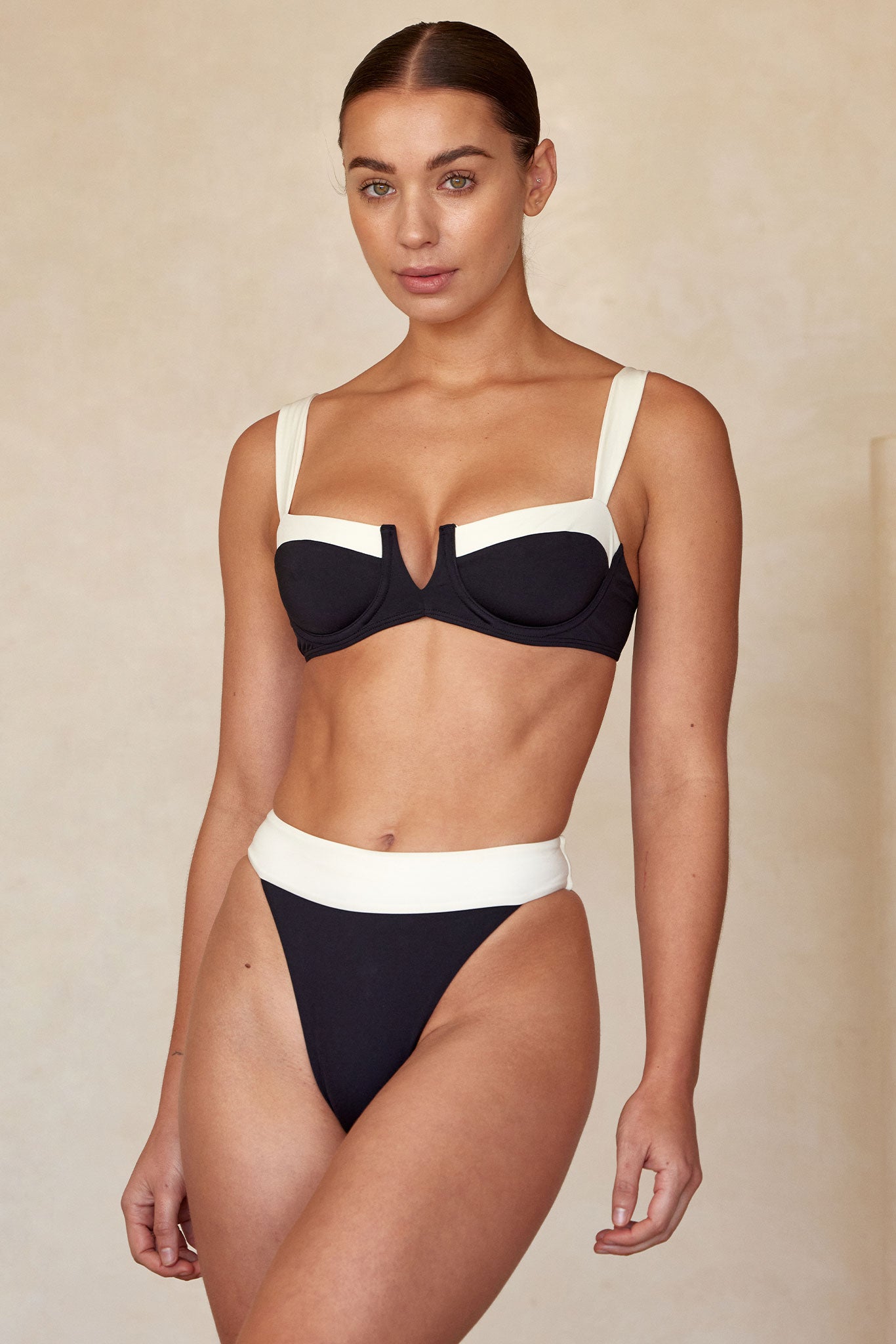 Model Liv wearing a black-and-white underwire bikini top and high-cut matching bottoms against a neutral backdrop.