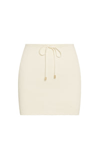 Cream ribbed knit mini skirt with drawstring waist and gold-tone aglets