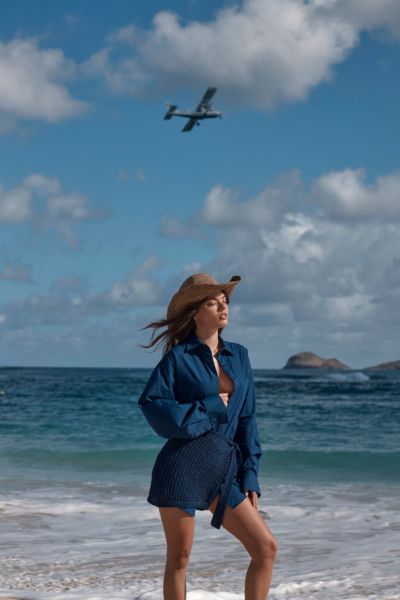 Three-quarter view of La Jolla Shirt in Midnight on model, showing relaxed fit, collar and front buttons on the beach