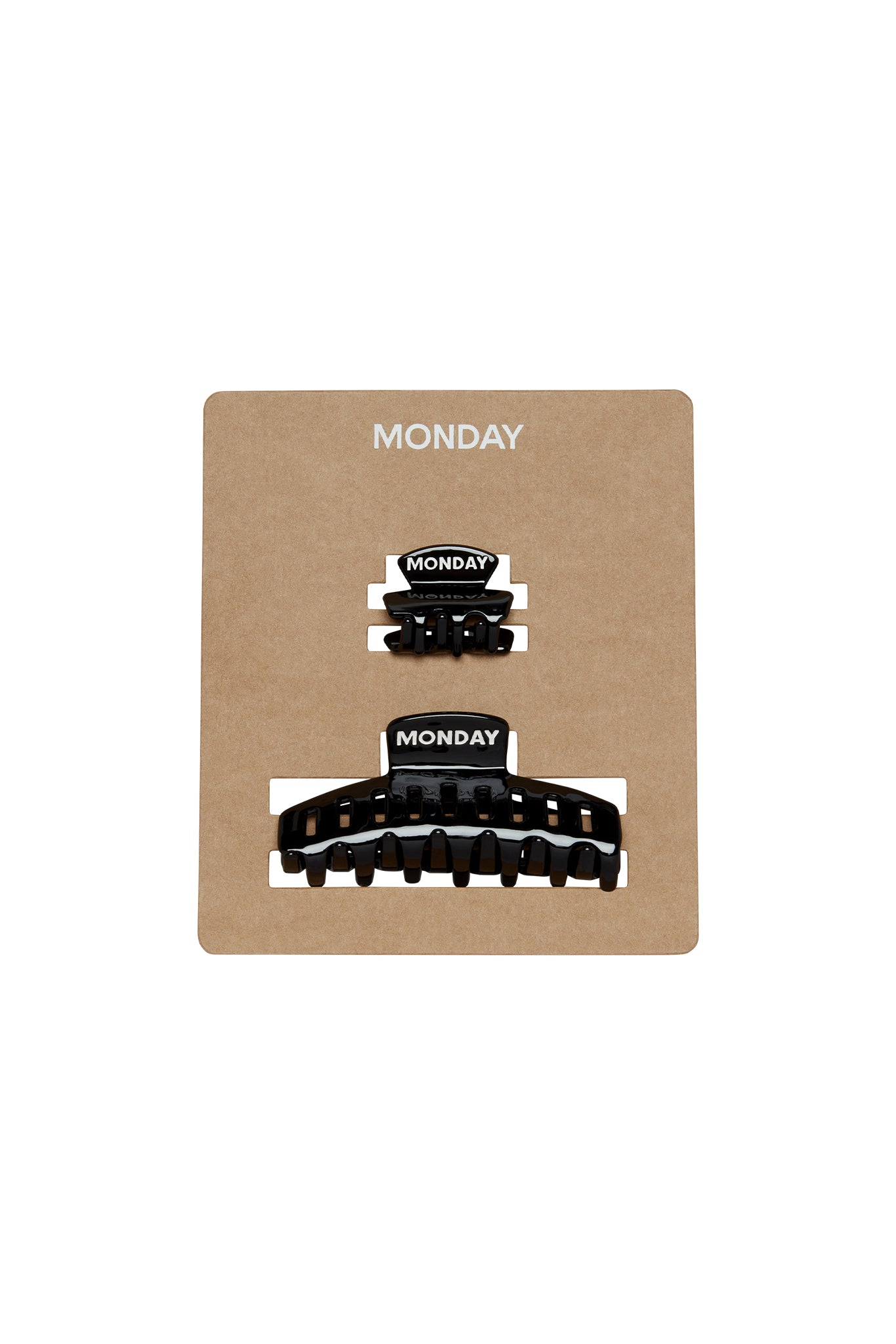 Two black hair claw clips labeled MONDAY on a brown display card