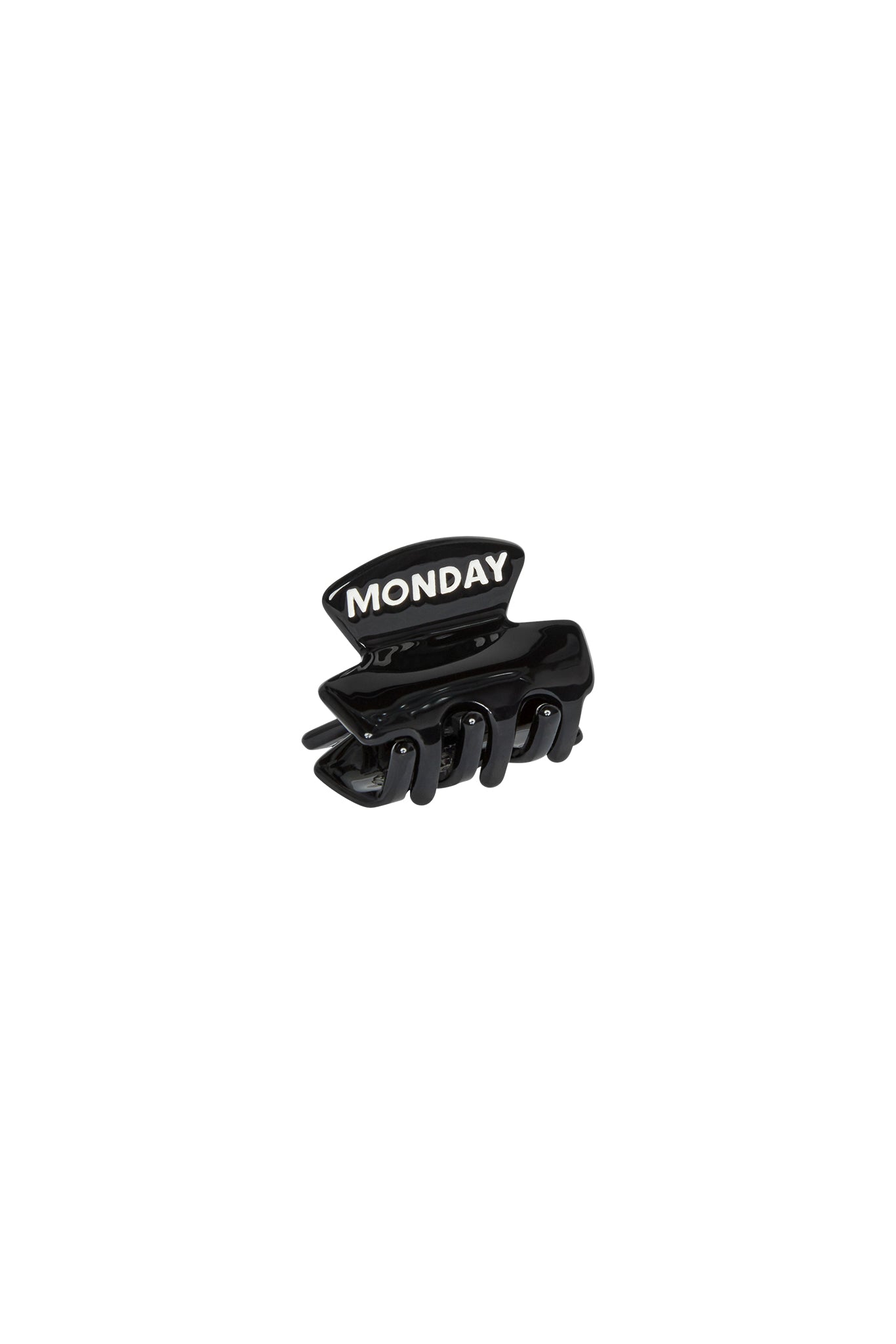 Black plastic hair claw clip with raised white letters reading MONDAY