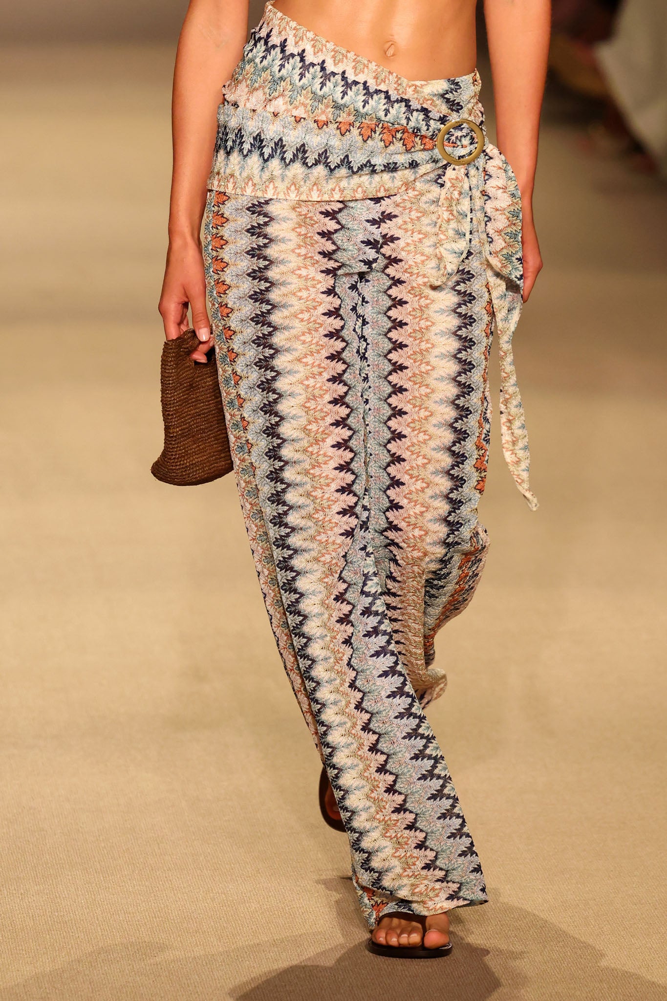 Close up front view of Toulon Pant in Porto Cervo Multi showing multicolor zigzag knit, wrap waist with gold ring on runway