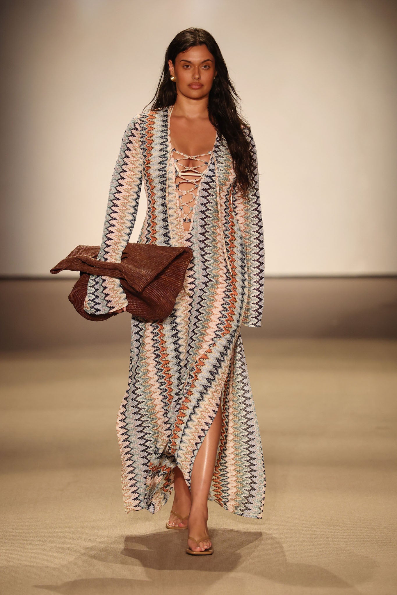 Front view of Corossol Dress - Porto Cervo Multi on model, lace-up front, long sleeves, side slit, zigzag multicolor knit