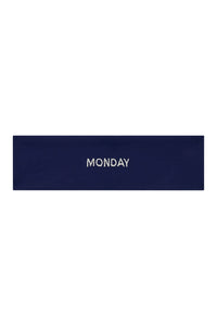 Flat lay of Monday Headband in midnight navy showing centered white "MONDAY" embroidery on a white background