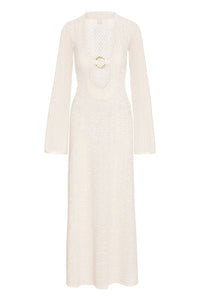 Front view of Montego Dress in ivory crochet with deep scoop neckline and gold ring, long bell sleeves, and floor-length skirt on white background