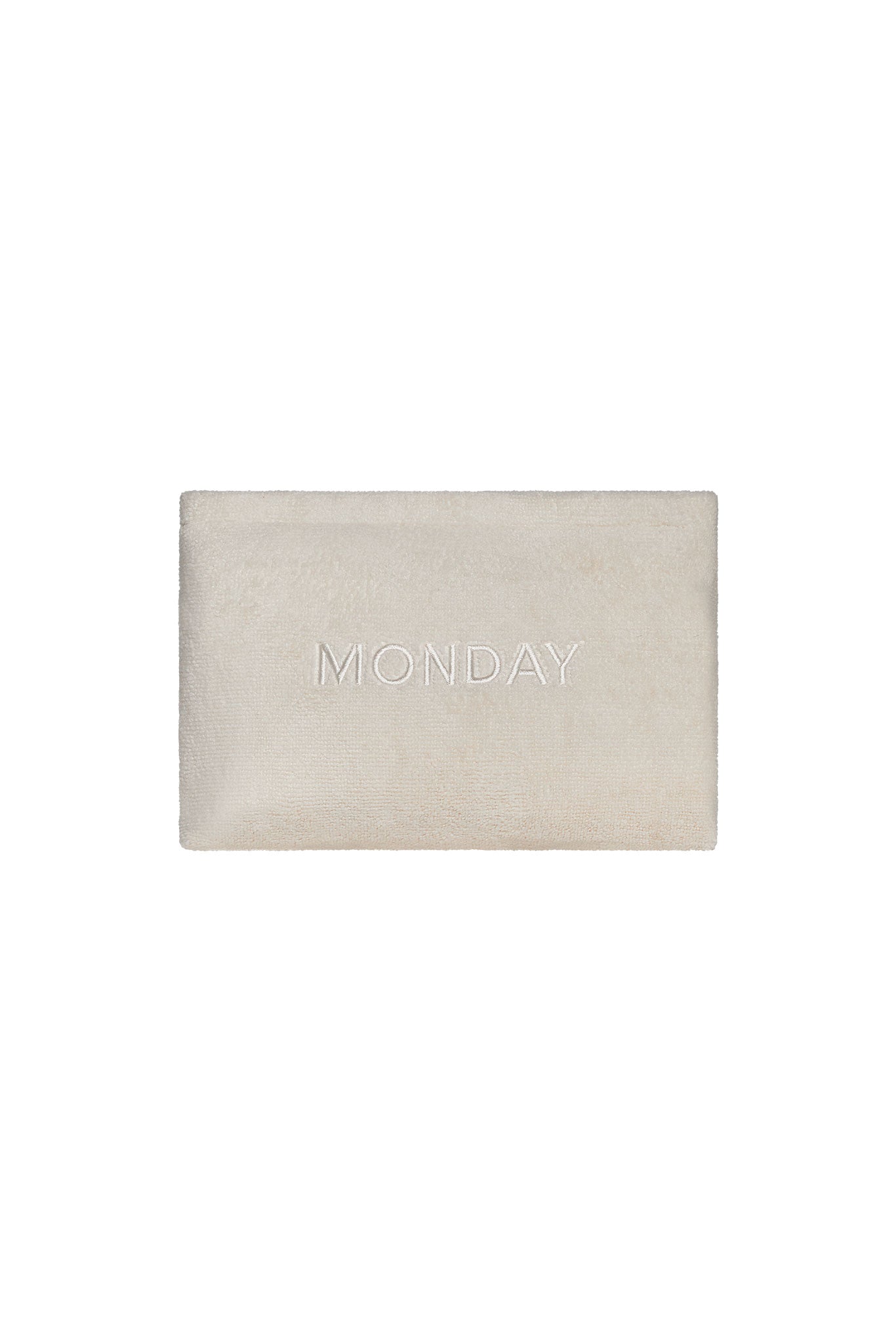 Beige rectangular bath mat with centered embroidered text "MONDAY"