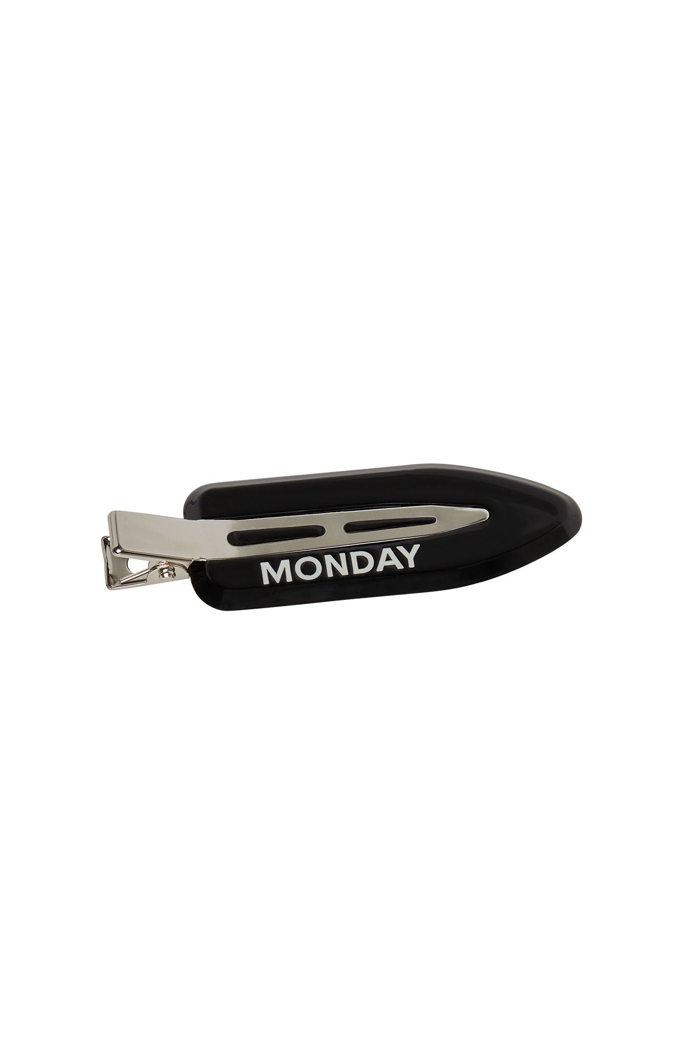 Black metal hair clip labeled MONDAY in white lettering.