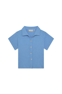 Front view of Pacific Beach kids short-sleeve button-up shirt in Azure Crinkle showing camp collar, buttons, and crinkled rayon-linen texture on white background