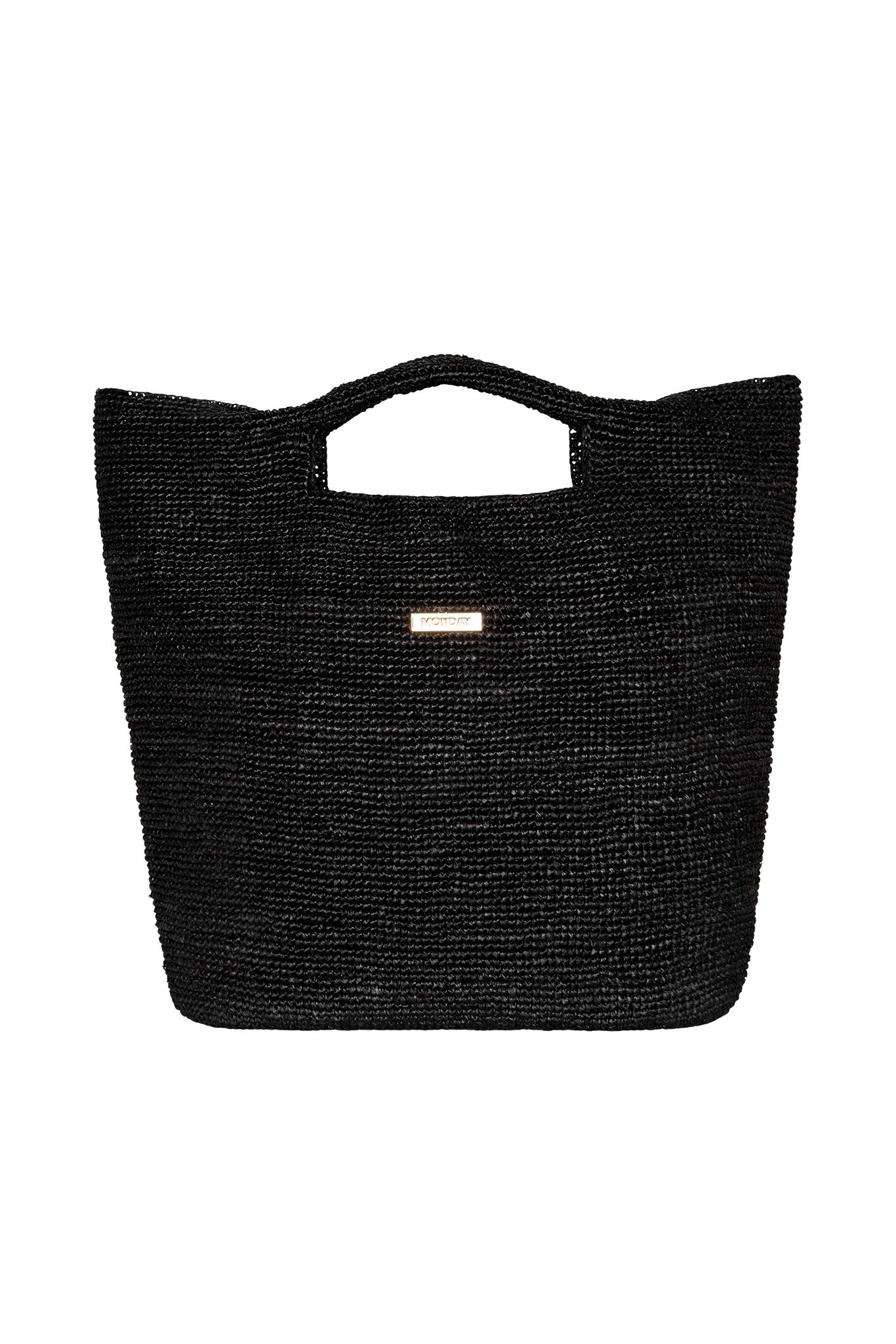 Black woven tote bag with built-in handhold and small rectangular plaque reading MONDAY