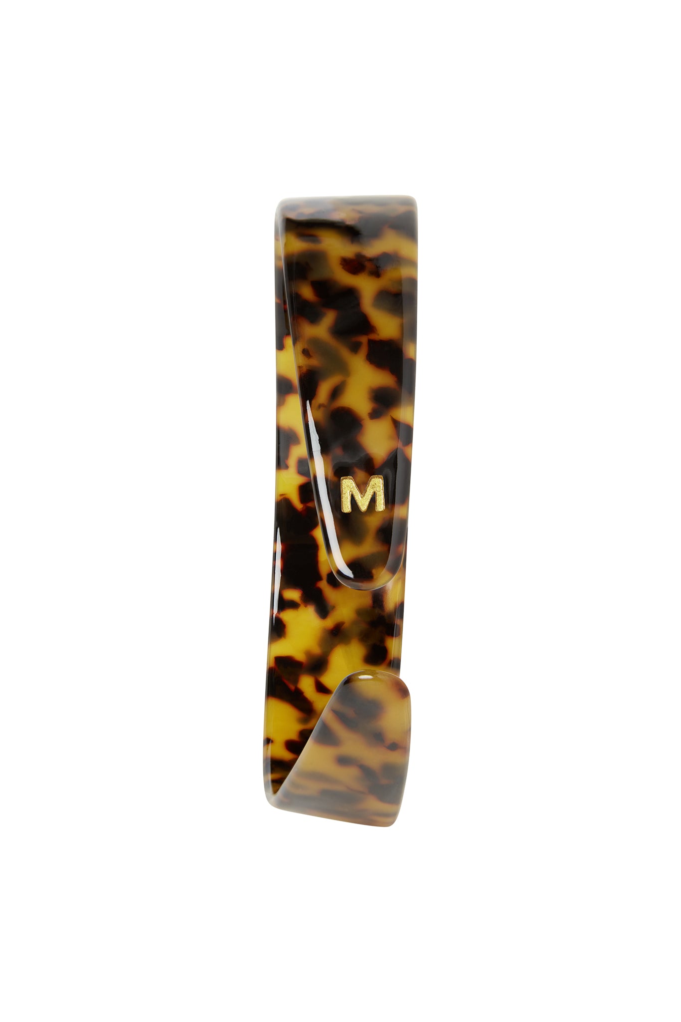 Tortoiseshell-patterned hair clip with a small gold M initial on the front.
