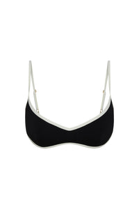 Front view of Soho Bra in black with ivory trim, showing V-neckline, thin adjustable straps and contrast colorblock on white background