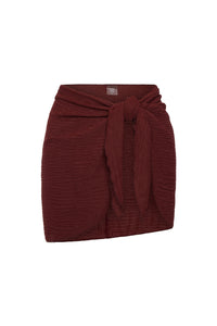 Front view of St Barths skirt in deep burgundy crinkle showcasing a tie waist with a white background