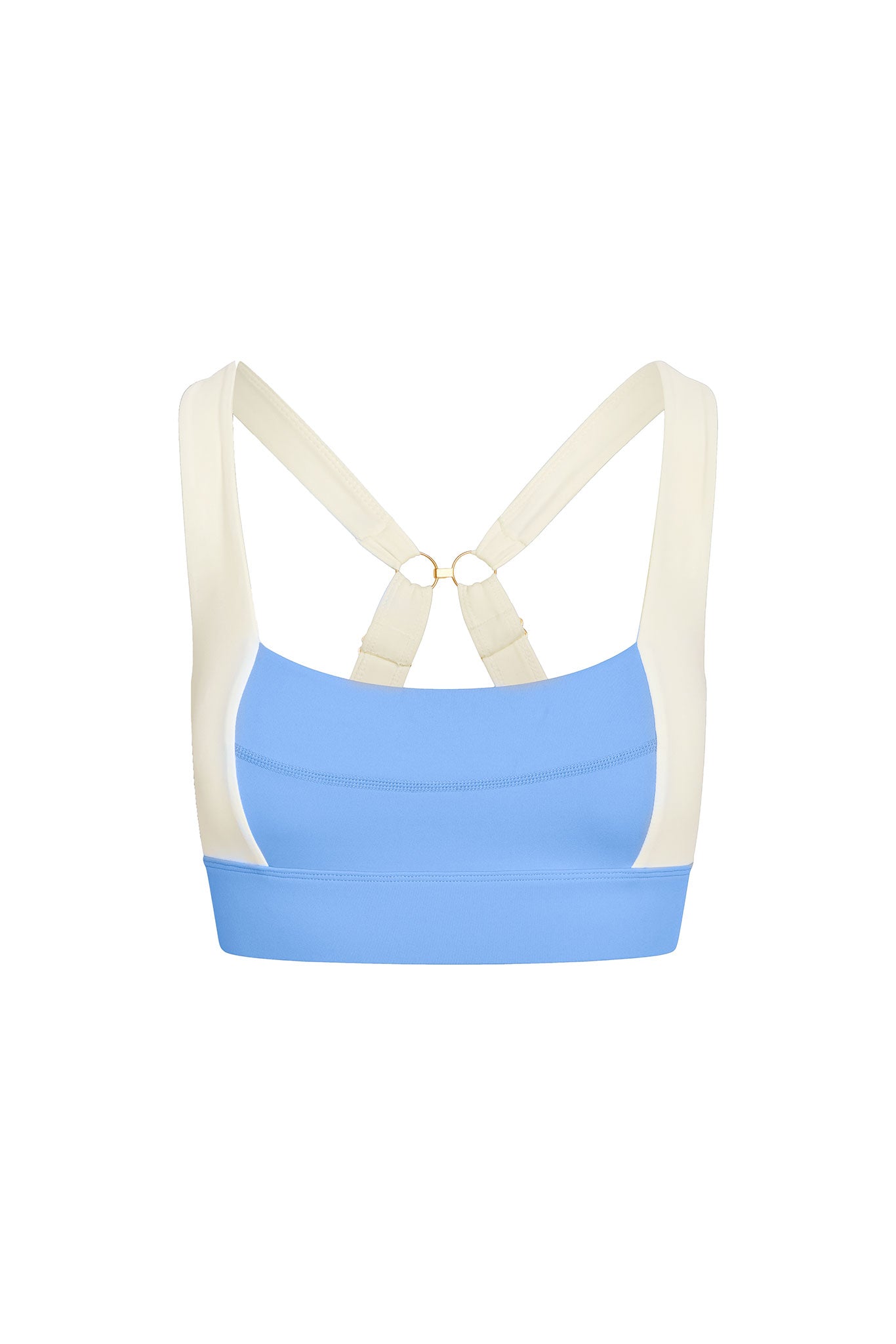 Light-blue sports bra with cream cross-back straps and gold ring connectors, scoop front and wide underband