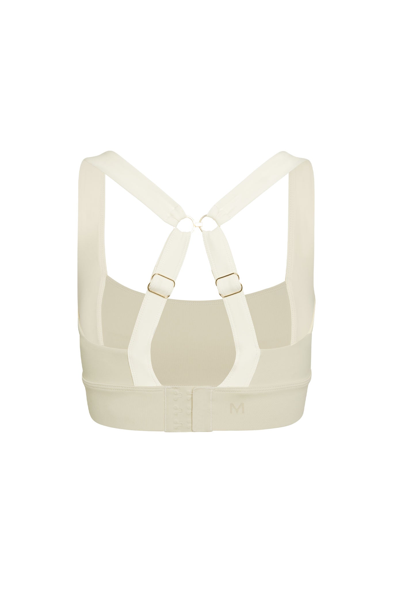 Cream-colored sports bra, back view with crisscross adjustable straps, hook-and-eye closure; band embossed M.