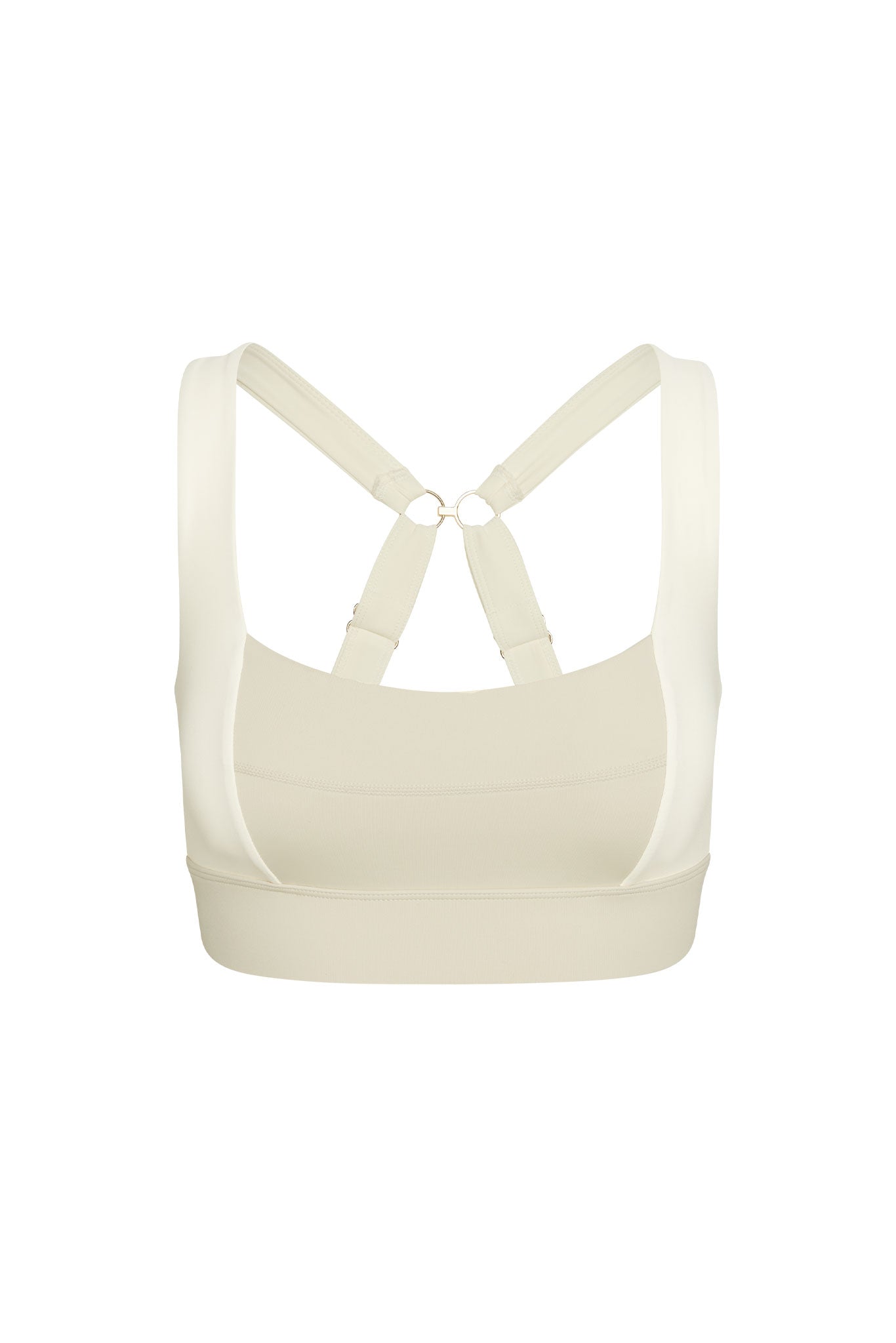 Beige sports bra, back view; crossed adjustable straps meeting at small metal rings and wide supportive underband.