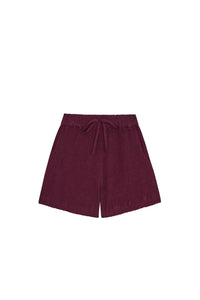 Front view of kids' Tuscany shorts in fig showing elastic waist with faux tie, crinkled fabric and side pockets on white