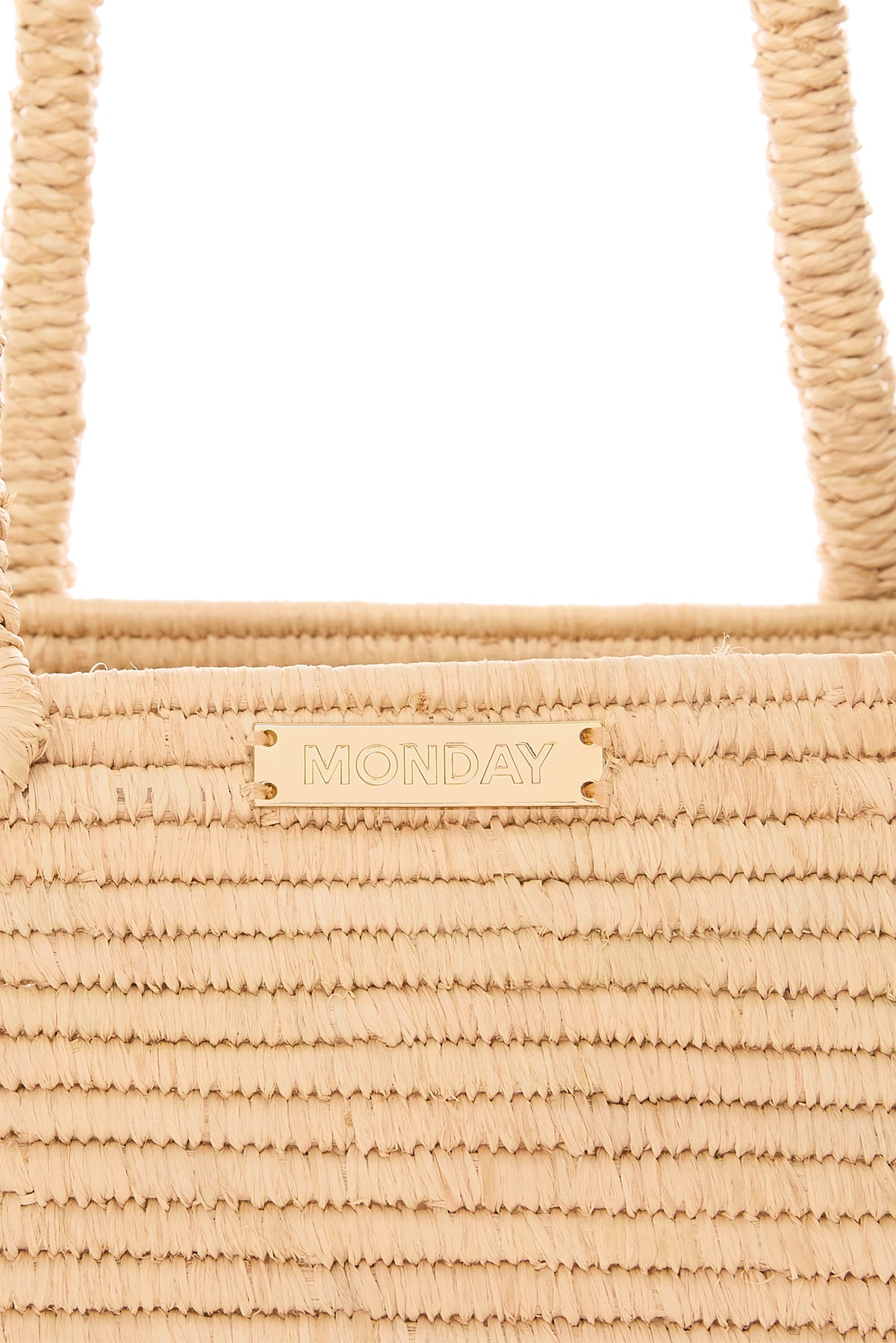 Close-up front of Valencia Bag - Large showcasing woven raffia texture, braided handles, and gold MONDAY plaque on white background