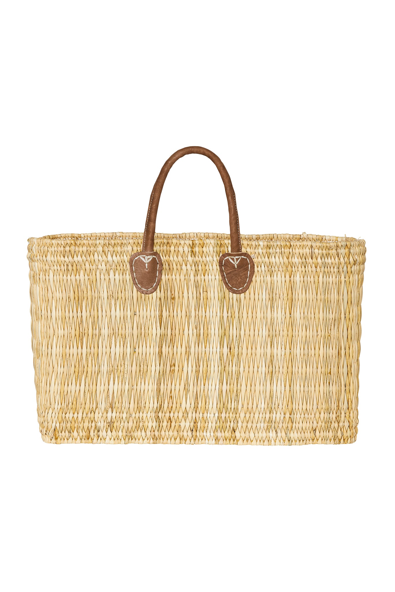 Rectangular woven straw tote bag with short brown leather handles and stitched leather reinforcements.