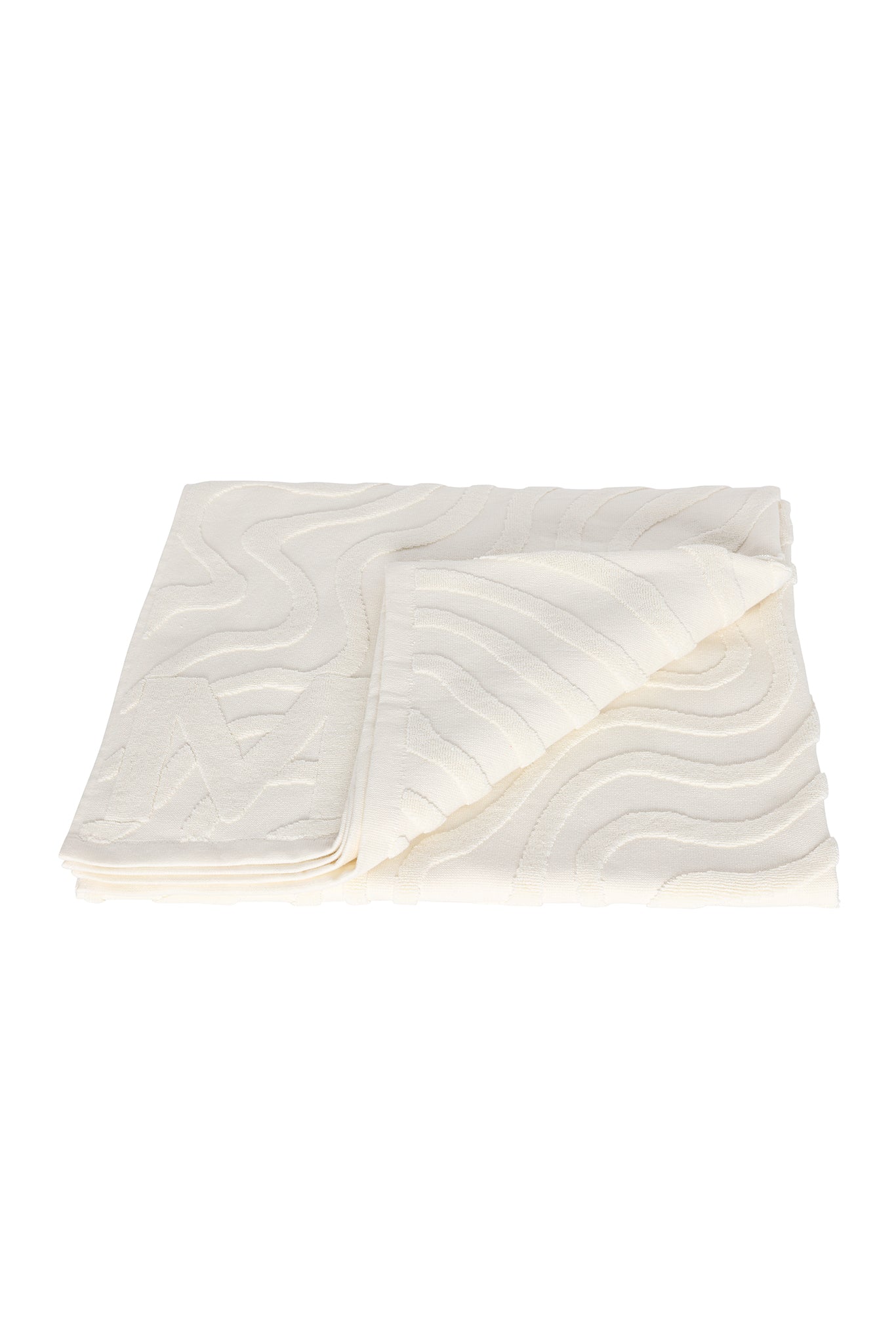 Folded cream bath towel with raised wavy textured pattern and a folded corner showing front and back