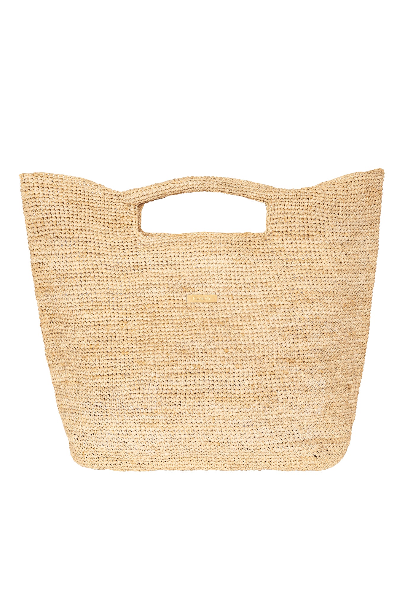 Woven natural straw tote bag with built-in top handles and small rectangular brand plaque reading MONDAY.