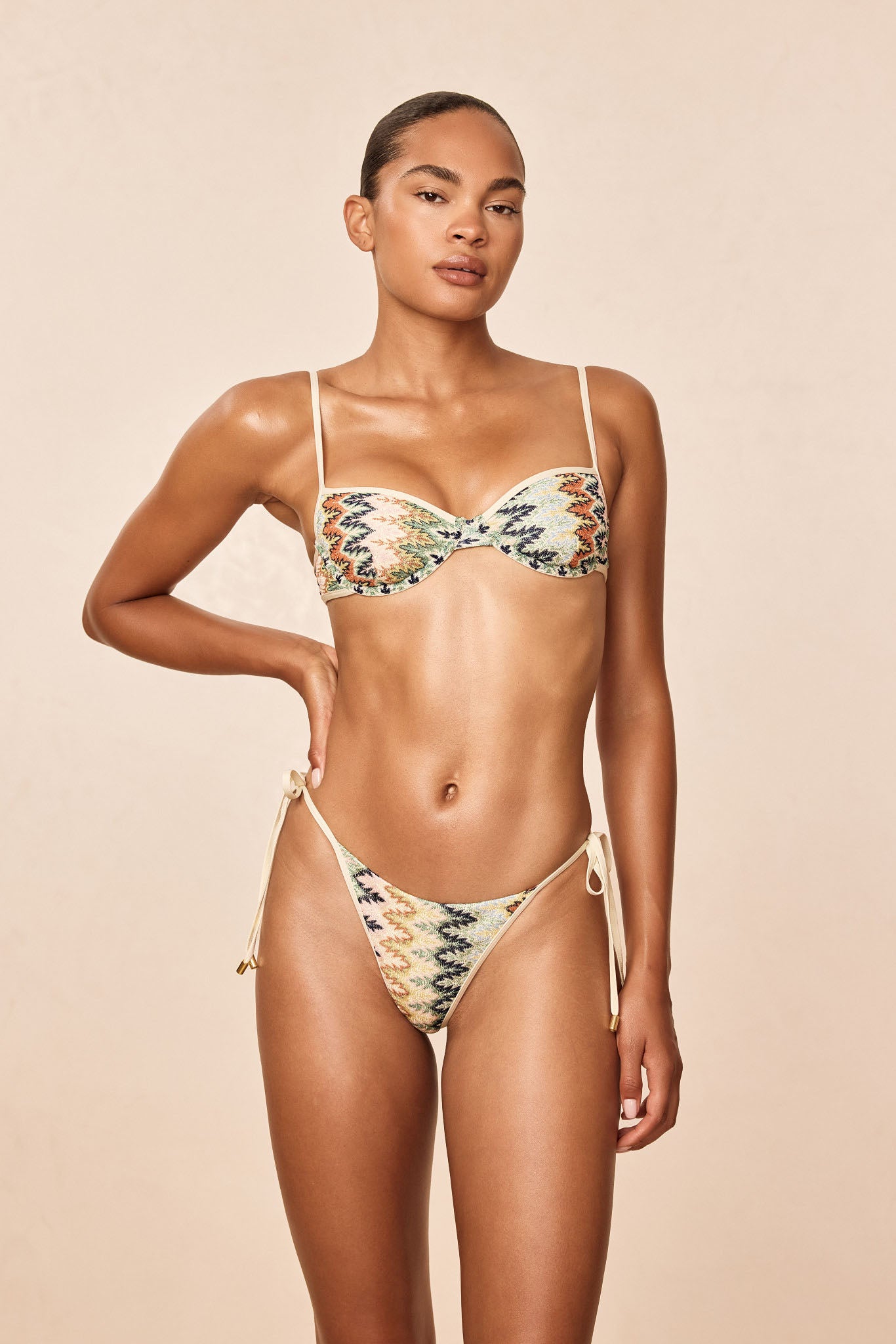 Front view of Capri Color Block Top in Porto Cervo Multi showing balconette underwire shape, thin adjustable straps on a beige studio background