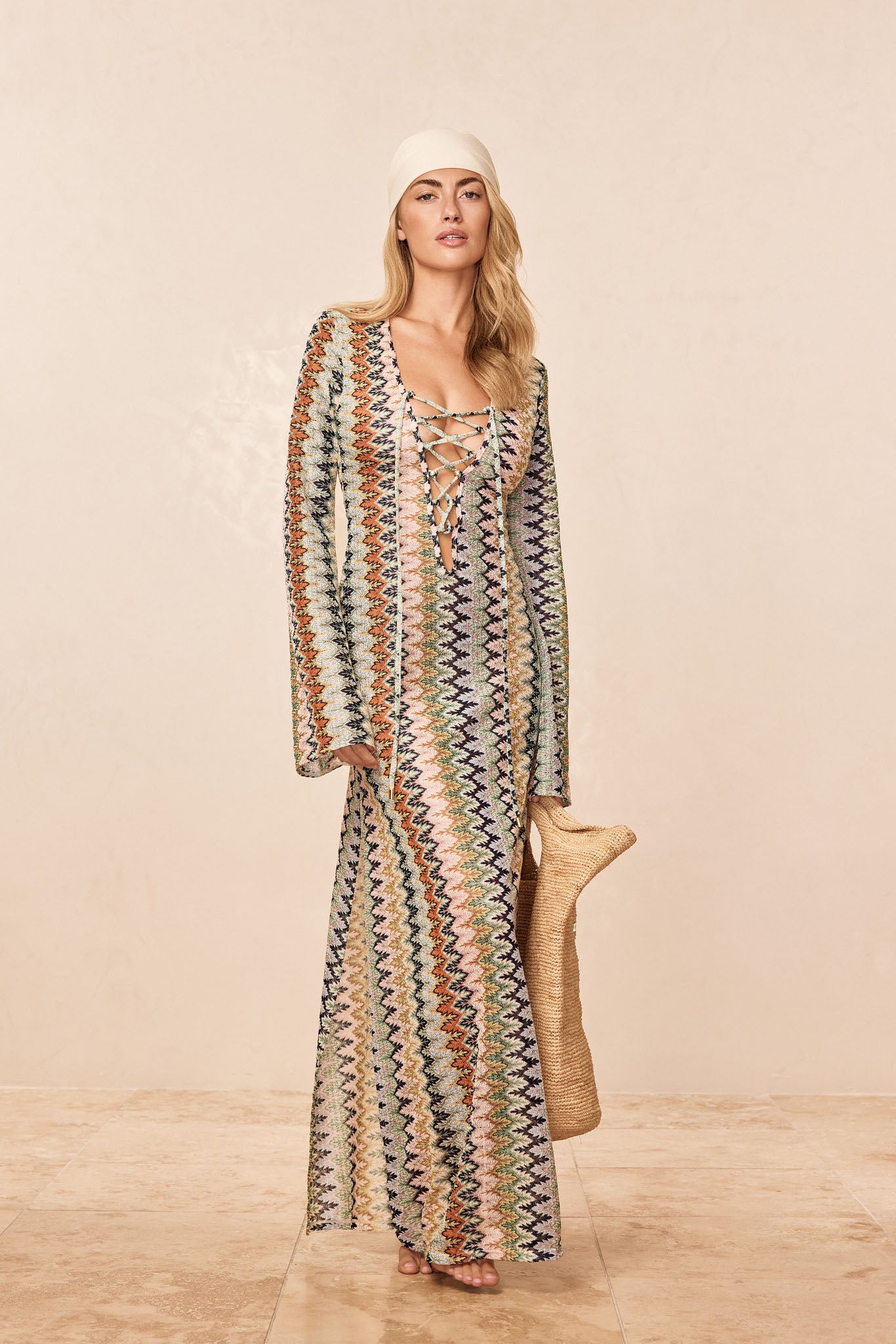 Front of Corossol dress in Porto Cervo multi with lace-up V neckline, bell sleeves, maxi length, and multicolor zigzag