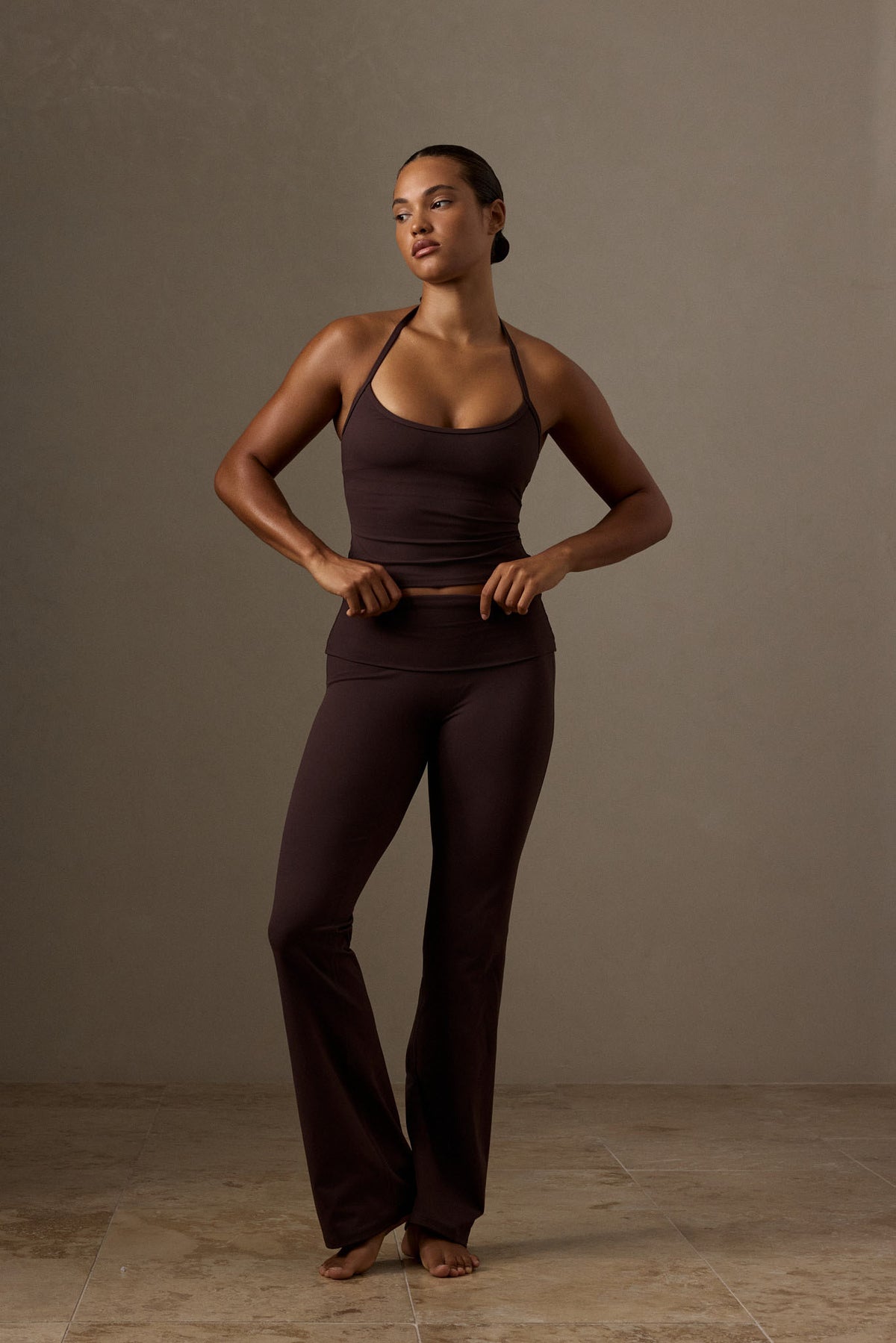 Front view of Melrose Flared Legging Long in Espresso with adjustable fold over waistband and flared legs against a studio background