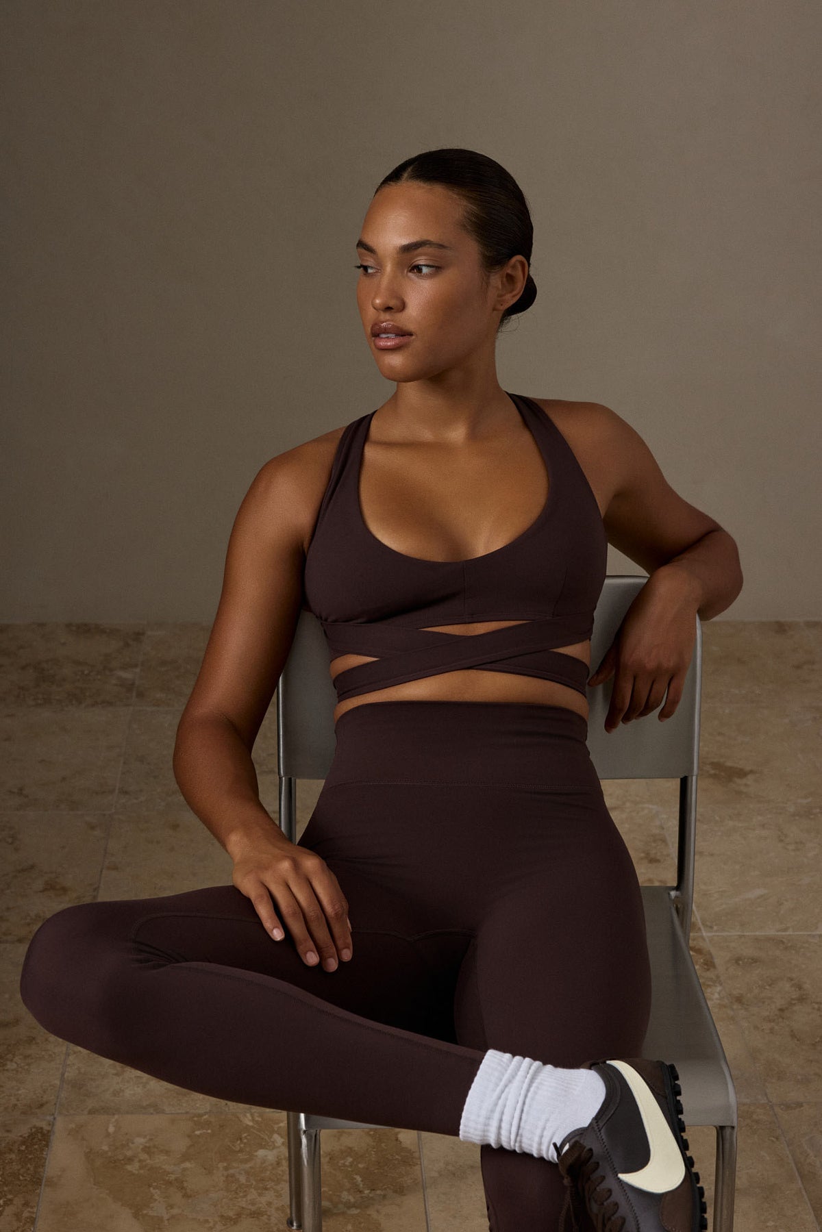 Front view of the Espresso Hudson Bra showcasing its V neck and wraparound straps on a seated model