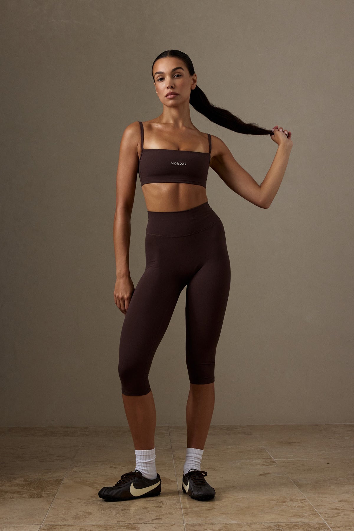 Front view of Acadia Legging Cropped in Espresso showcasing the high waist and cropped length on a model