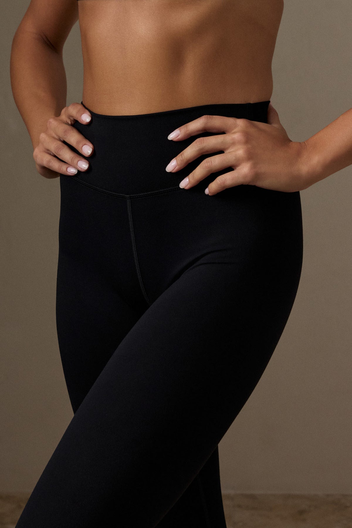 Close-up of Topanga Legging showcasing the mid-rise waistband and front seam with a neutral background