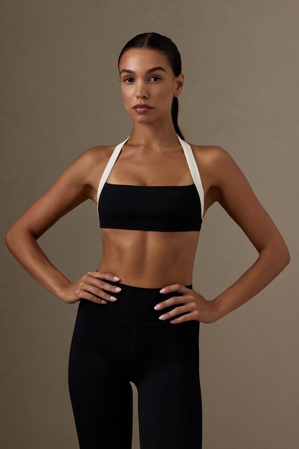 Front view of Tribeca Halter Bra in black and ivory showcasing wide halter straps on a model against a neutral background