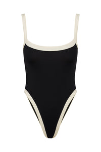 Front view of Barcelona One Piece in Black/Ivory with ivory trim, adjustable straps, and high leg on white