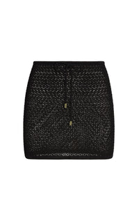 Black crochet-knit mini skirt with front drawstring and gold-tone aglets on white background.