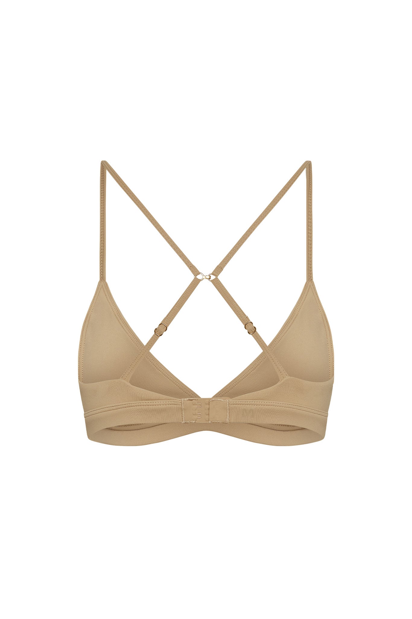 Beige wireless bralette with adjustable crisscross straps and back hook-and-eye closure.