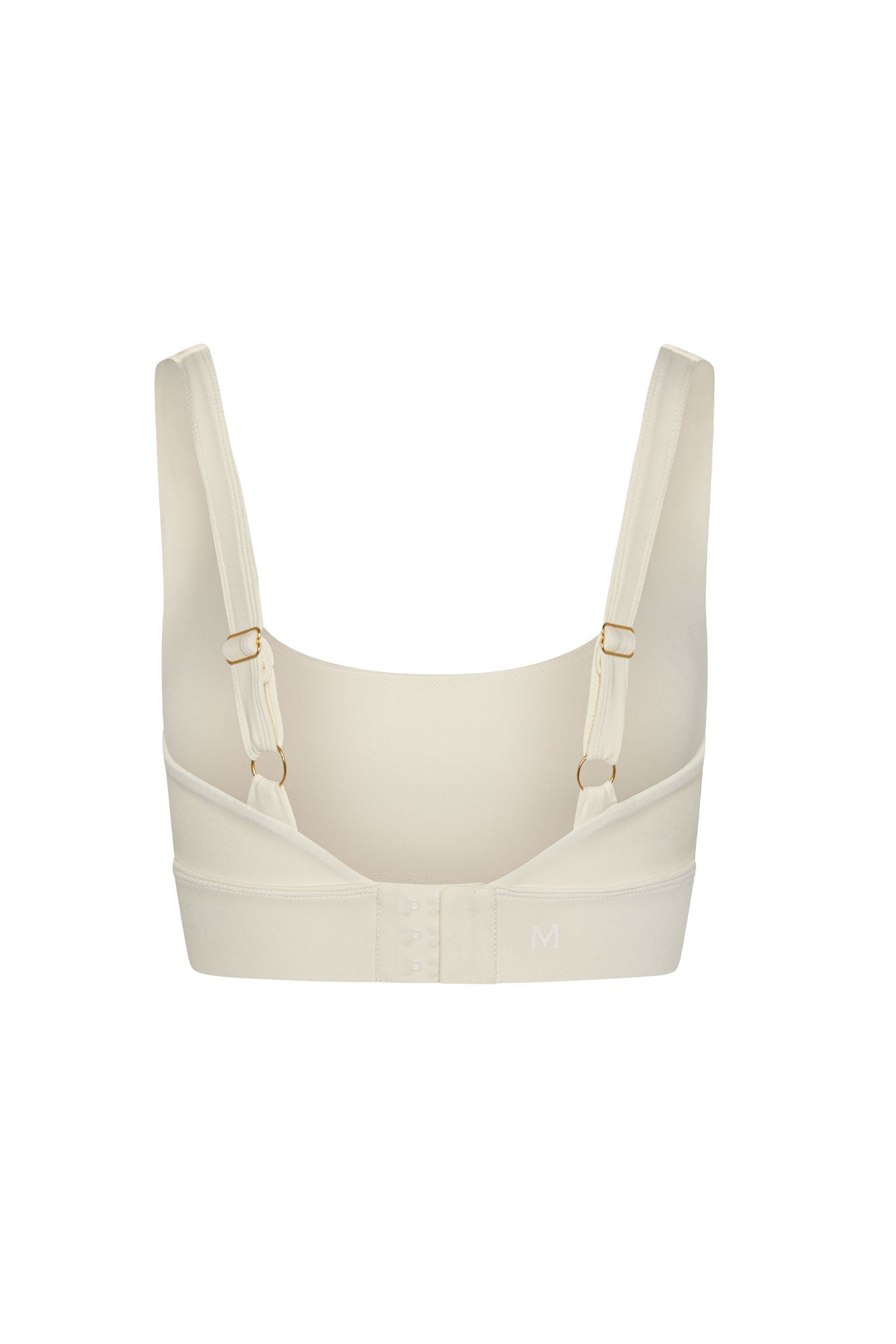 Cream wireless bra back view with adjustable straps, hook-and-eye closure and embroidered M on the band