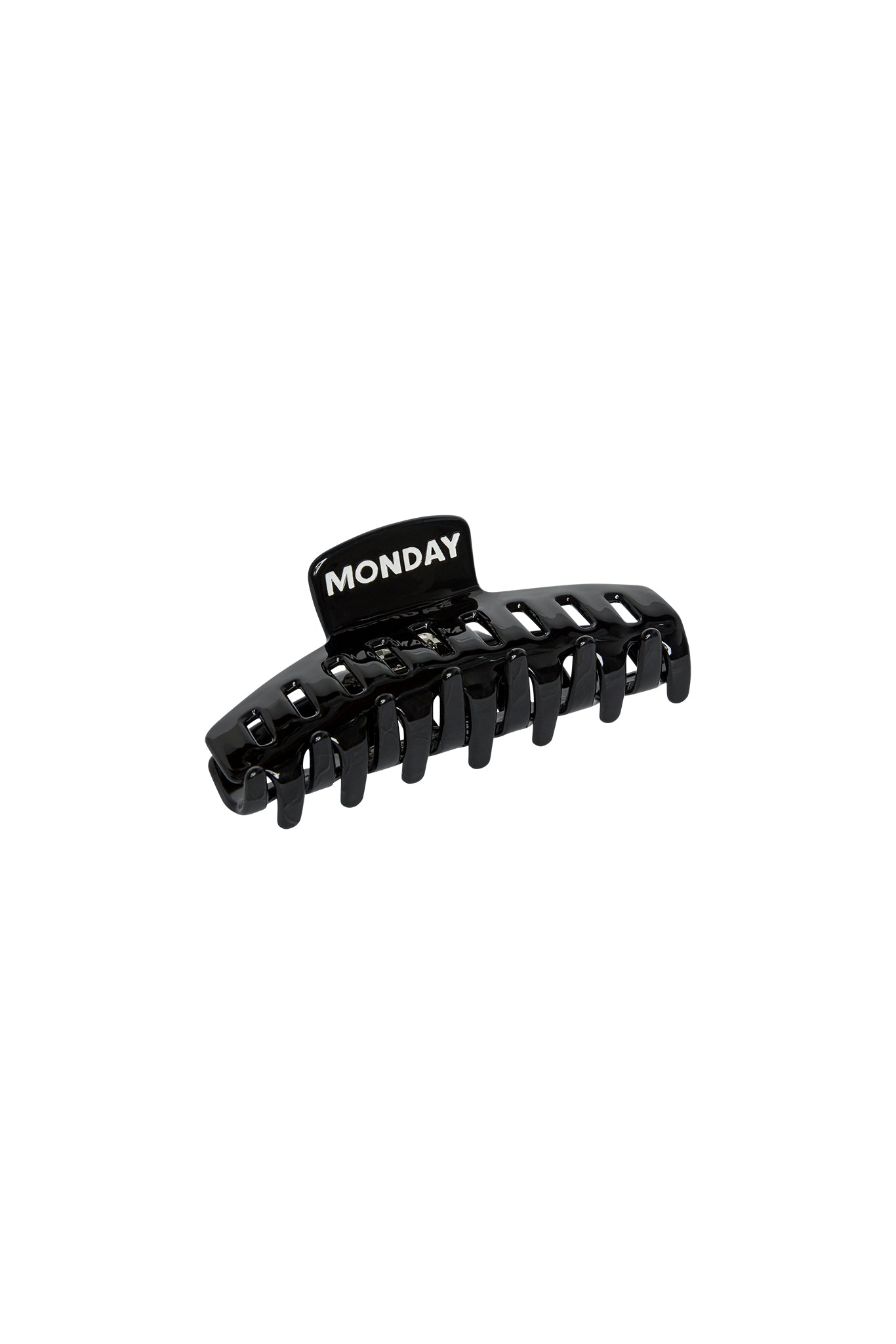 Black plastic hair claw clip with tab labeled MONDAY