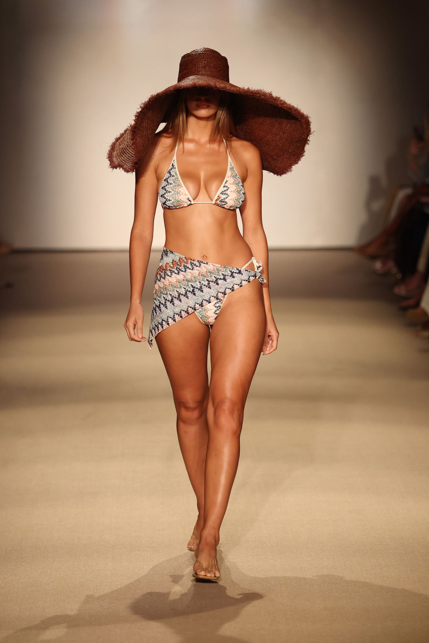 Front view of Palma color-block bikini top Porto Cervo Multi on model with matching wrap bottom on runway