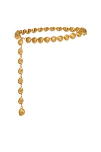 Reclining view of Shell Belt in gold showcasing scalloped 18K gold-plated shell medallions and dangling beaded tassel on white background