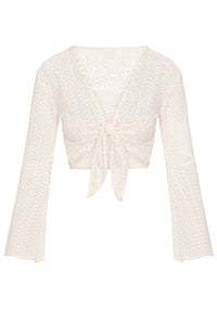 Front view of St. Barth's top in ivory crochet, tie-front cropped knit with long bell sleeves on white background