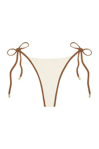 Front view of Palma Thong showing ivory color block panel with caramel brown trim and tie-side straps with gold tips on white background