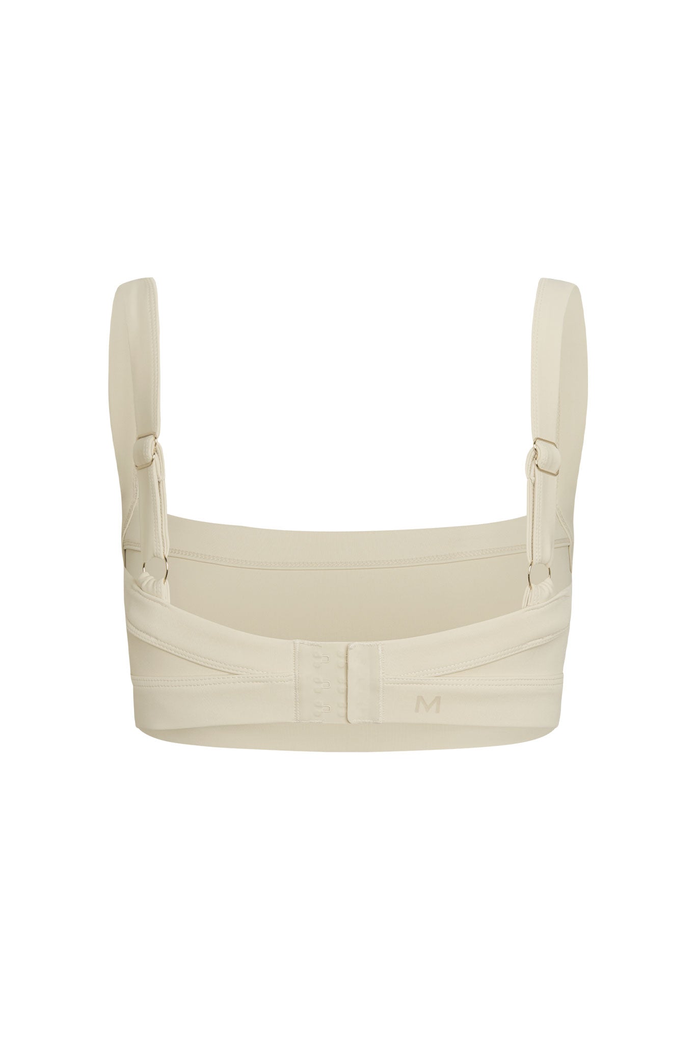 Beige supportive bra back with adjustable straps and three-row hook-and-eye closure, size marker M visible.