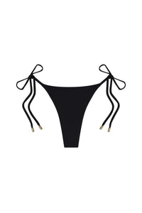 Front view of Palma Thong in black showcasing adjustable side ties and gold hardware on white background