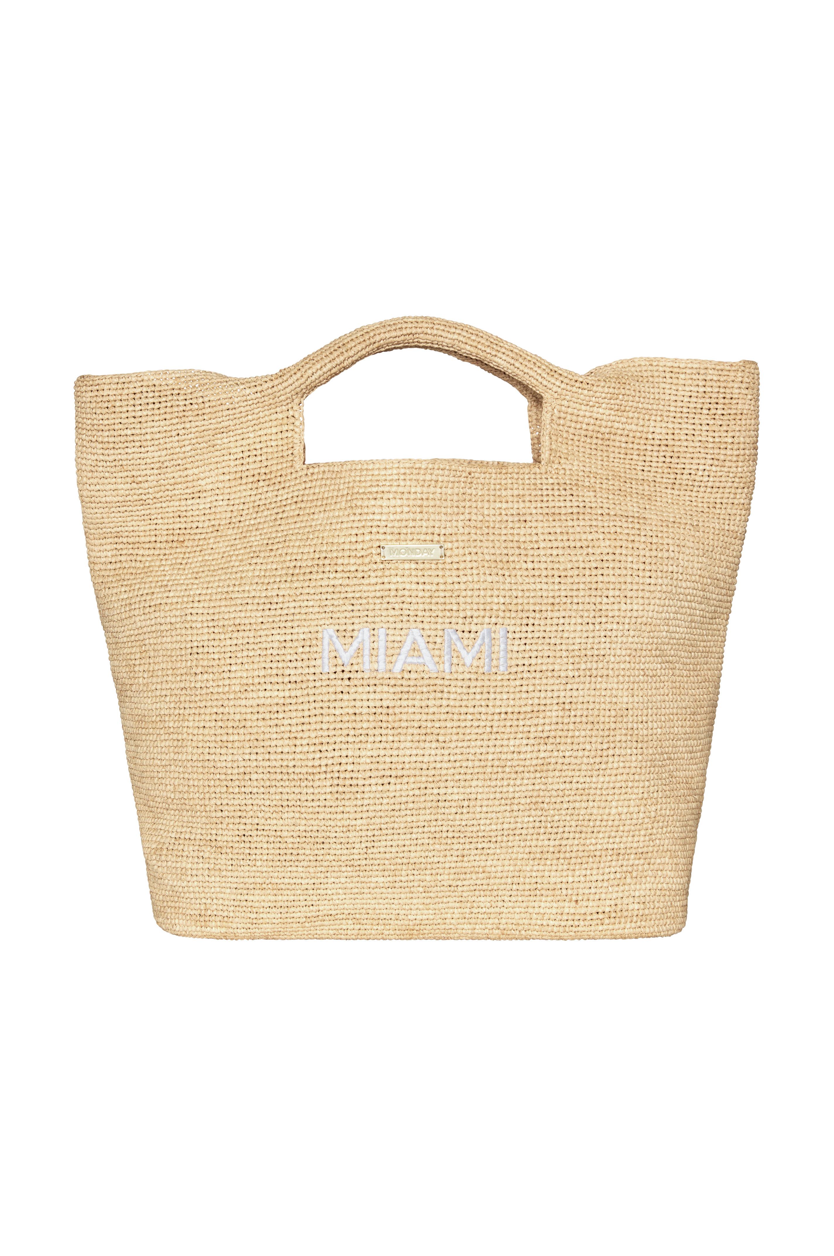 Woven straw tote bag with MIAMI embroidered on front and small rectangular "MONDAY" brand plaque near the handle.