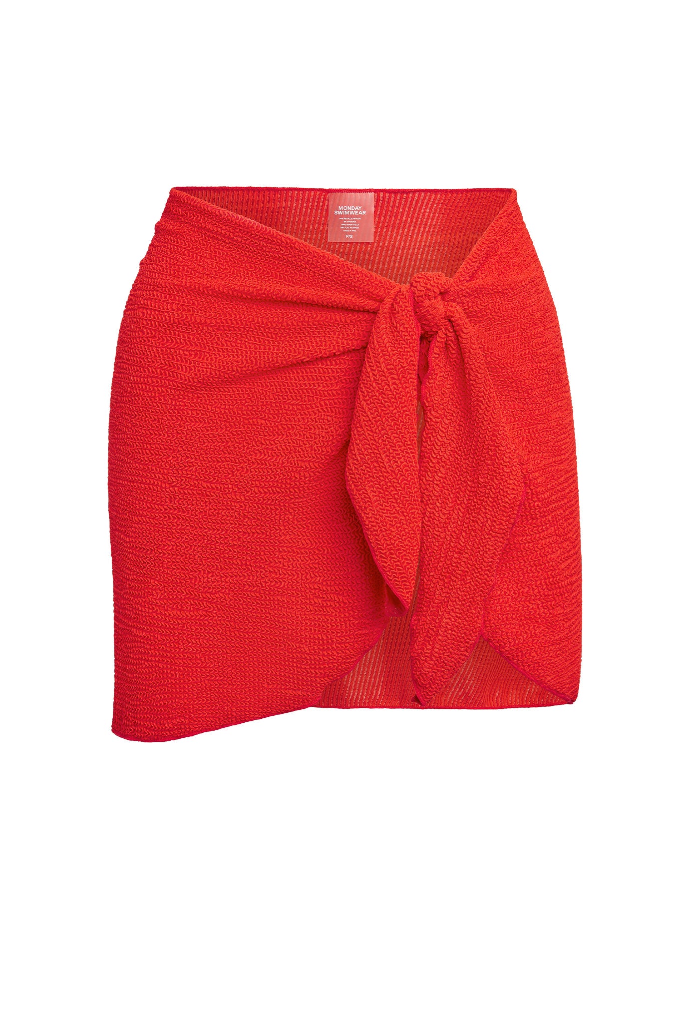 Red textured tie-front sarong-style skirt with label reading 'MONDAY SWIMWEAR'.