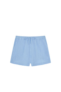 Front flat lay of Tuscany Short Kids in sky blue showcasing crinkle texture, elastic waist with faux tie and side pockets on white background